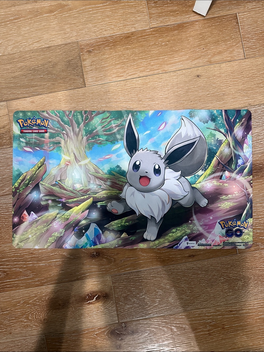 Pokemon Playmat Featuring Eevee in Green, Blue, Purple Artwork